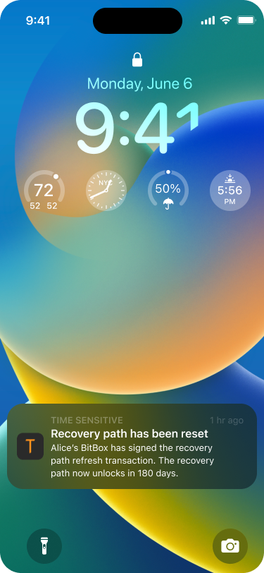 Smartphone lock screen showing a push notification that says that Alice has just signed the transaction as well and that the recovery path has been reset.